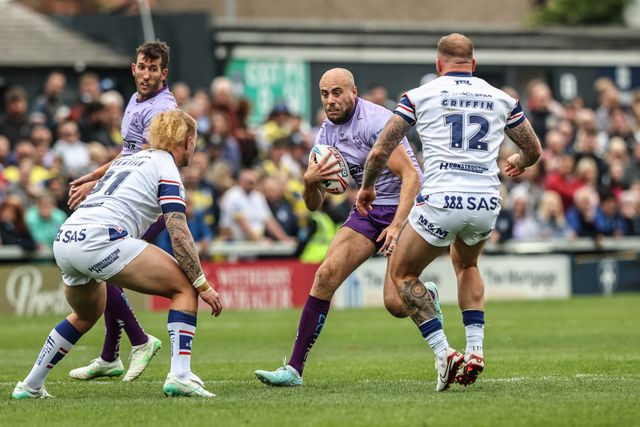 James Harrison of Warrington Wolves is tackled by Caius Faatili of Wakefield Trinity and Josh Griffin of Wakefield Trinity during the Betfred Super League Round 11 match Wakefield Trinity vs Warrington Wolves at DIY Kitchens Stadium, Wakefield, United Kingdom, 18th May 2025

(Photo by Alfie Cosgrove/News Images)