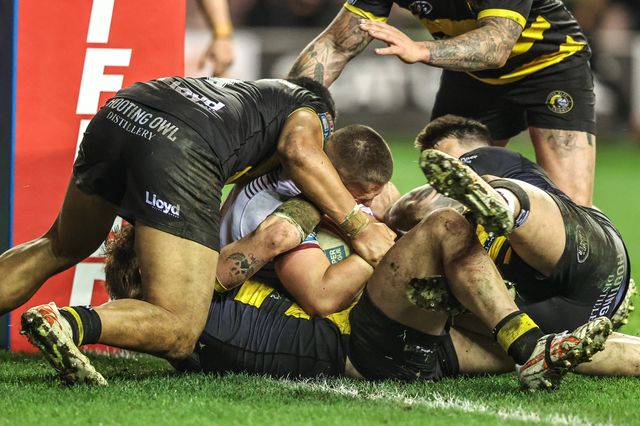 Brad O'Neill of Wigan Warriors is tackled on the try line during the Betfred Super League round 5 match Wigan Warriors vs York Knights at The Brick Community Stadium, Wigan, United Kingdom on 19 March 2026

(Photo by Alfie Cosgrove/News Images)