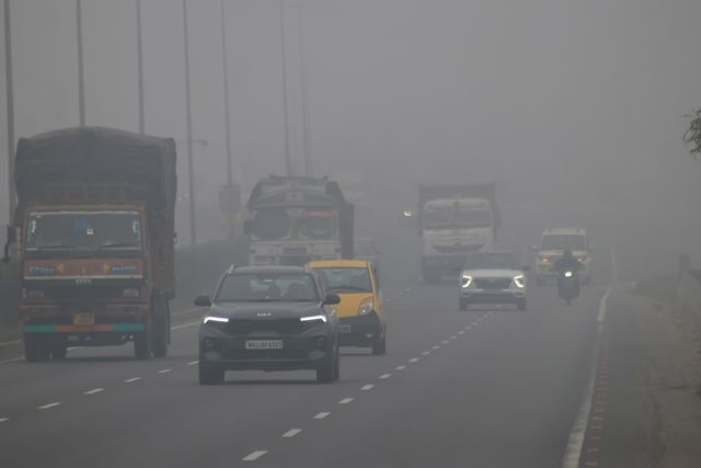 Commuters ride along National Highway NH12 amid dense fog on a cold winter morning in Howrah,West Bengal,Pictures by Debajyoti Chakraborty.(Photo: Debajyoti Chakraborty/News Images)