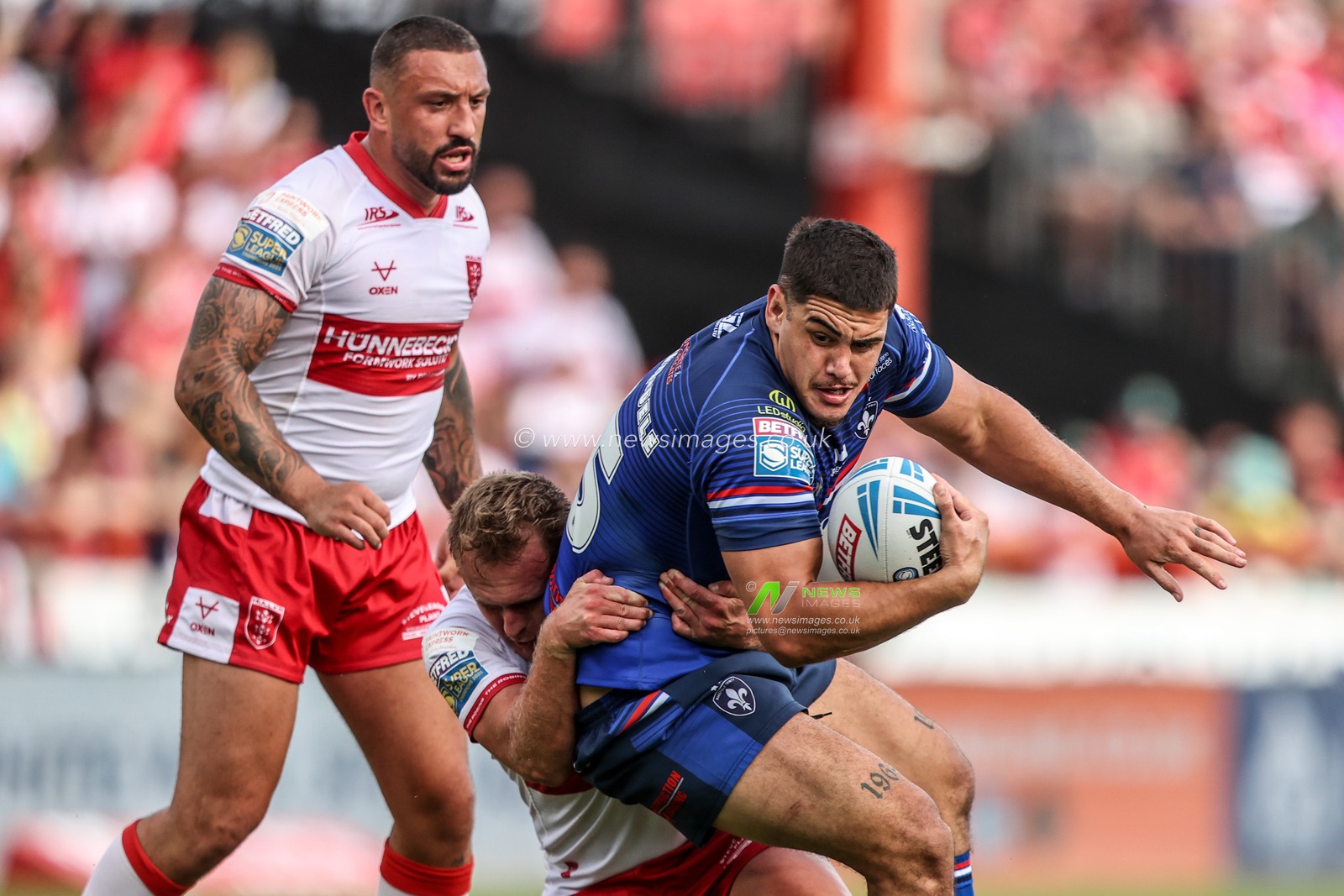 Caleb Hamlin-Uele of Wakefield Trinity is tackled by Elliot Minchella of Hull KR and Jez Litten of Hull KR during the Betfred Super League round 18 match Hull KR vs Wakefield Trinity at Sewell Group Craven Park, Hull, United Kingdom on 11 July 2026

(Photo by Alfie Cosgrove/News Images)
