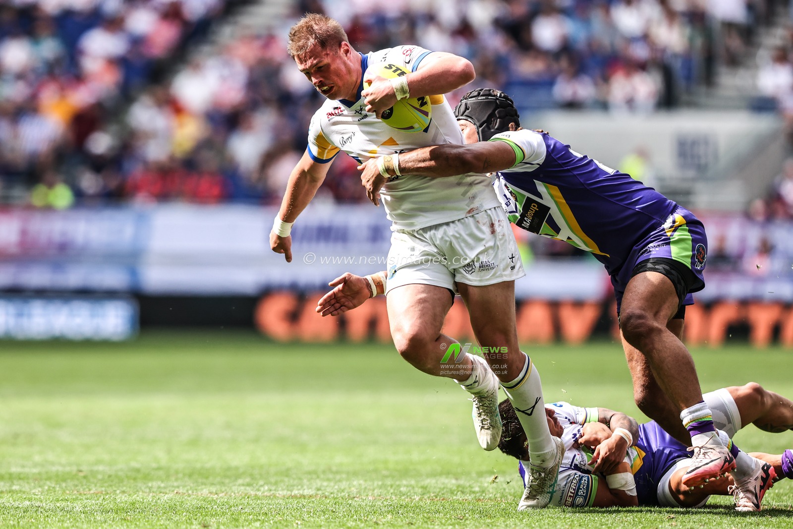 Tom Holroyd of Leeds Rhinos is tackled by Guy Armitage of Bradford Bulls during the Betfred Super League Magic Weekend match Leeds Rhinos vs Bradford Bulls at Hill Dickinson Stadium, Liverpool, United Kingdom on 05 July 2026

(Photo by Alfie Cosgrove/News Images)