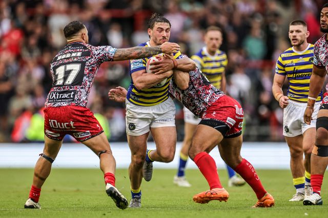 Adam Holroyd of Warrington Wolves is tackled by Liam Horne of Leigh Leopards and Isaac Liu of Leigh Leopards during the Betfred Super League round 20 match Leigh Leopards vs Warrington Wolves at Leigh Sports Village, Leigh, United Kingdom on 25 July 2026

(Photo by Alfie Cosgrove/News Images)