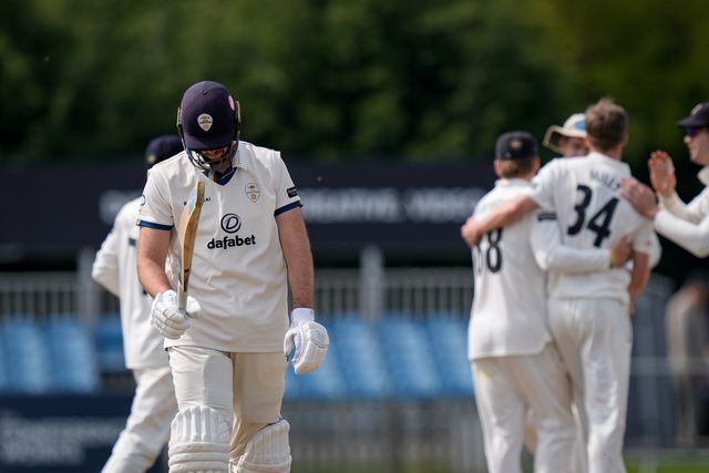 Ben Aitchison walks off after being caught by Cameron Bancroft off the bowling of Craig Miles as Gloucestershire players celebrate a wicket during the County Championship Division Two Derbyshire v Gloucestershire at The Central Co-Op County Ground, Derby, United Kingdom on 26 April 2026

(Photo by Maynard Manyowa/News Images)