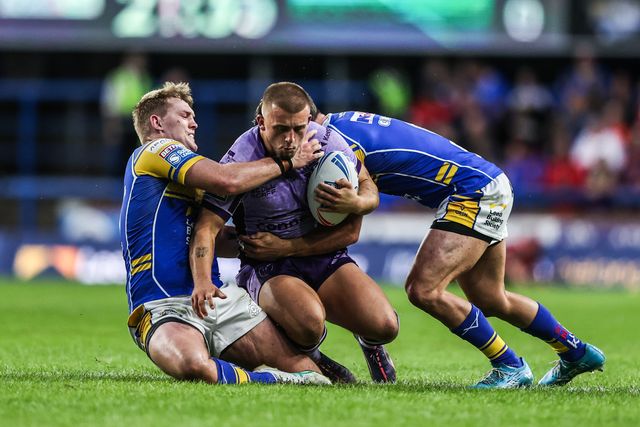 Mikey Lewis of Hull KR is tackled by James McDonnell of Leeds Rhinos and Brodie Croft of Leeds Rhinos  during the Betfred Super League round 23 match Leeds Rhinos vs Hull KR at Headingley Stadium, Leeds, United Kingdom, 21st August 2025

(Photo by Alfie Cosgrove/News Images)