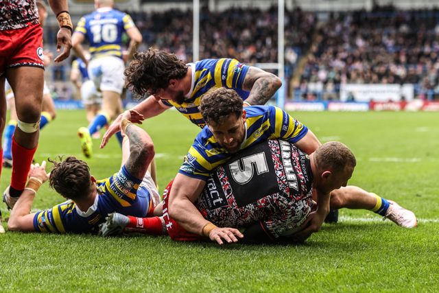 Josh Charnley of Leigh Leopards is tackled by Matty Ashton of Warrington Wolves and Toby King of Warrington Wolves during the Betfred Super League round 7 match Warrington Wolves vs Leigh Leopards at The Halliwell Jones Stadium, Warrington, United Kingdom on 04 April 2026

(Photo by Alfie Cosgrove/News Images)