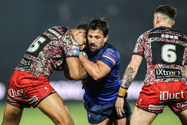 Tyson Smoothy of Wakefield Trinity is tackled by Jacob Alick-Wiencke of Leigh Leopards and Adam Cook of Leigh Leopards during the Betfred Super League round 5 match Wakefield Trinity vs Leigh Leopards at DIY Kitchens Stadium, Wakefield, United Kingdom on 20 March 2026

(Photo by Alfie Cosgrove/News Images)
