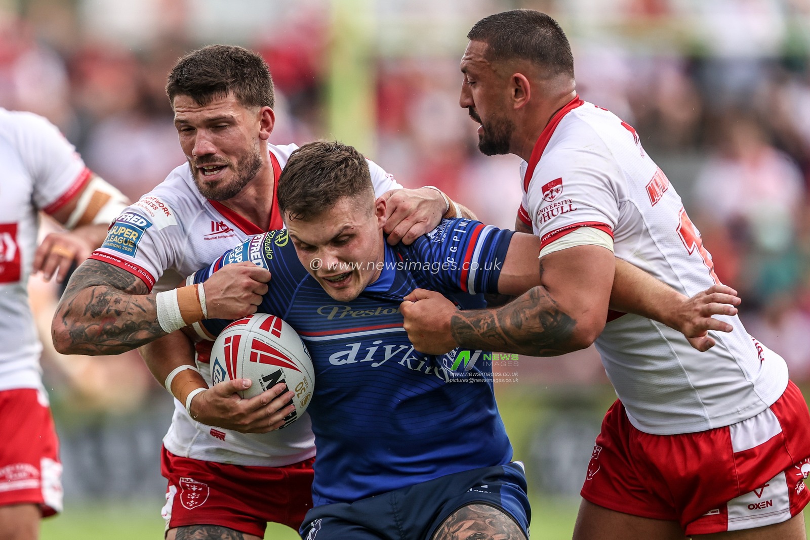 Cameron Scott of Wakefield Trinity is tackled by Elliot Minchella of Hull KR and Oliver Gildart of Hull KR during the Betfred Super League round 18 match Hull KR vs Wakefield Trinity at Sewell Group Craven Park, Hull, United Kingdom on 11 July 2026

(Photo by Alfie Cosgrove/News Images)