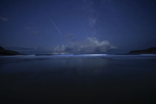 Bioluminescent plankton and the Milky Way shine on South Wales beach