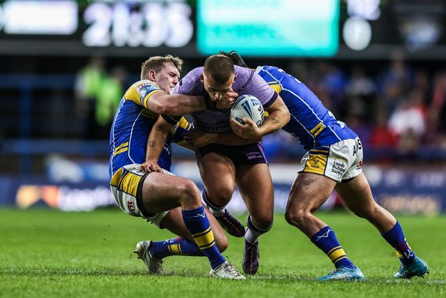 Mikey Lewis of Hull KR is tackled by James McDonnell of Leeds Rhinos and Brodie Croft of Leeds Rhinos  during the Betfred Super League round 23 match Leeds Rhinos vs Hull KR at Headingley Stadium, Leeds, United Kingdom, 21st August 2025

(Photo by Alfie Cosgrove/News Images)
