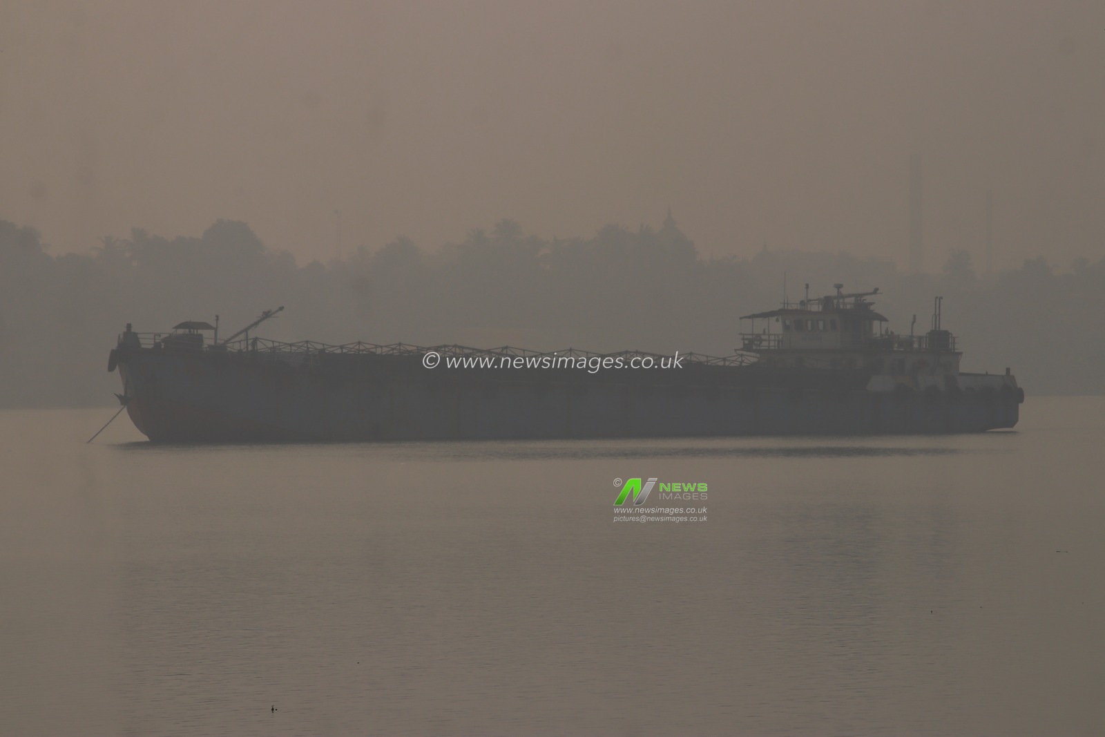 A cargo ship is parked the Ganga River on a dense, foggy morning amid rising air pollution levels in Kolkata, India, on January 4,2025.Pictures by Debajyoti Chakraborty.(Photo: Debajyoti Chakraborty/News Images)