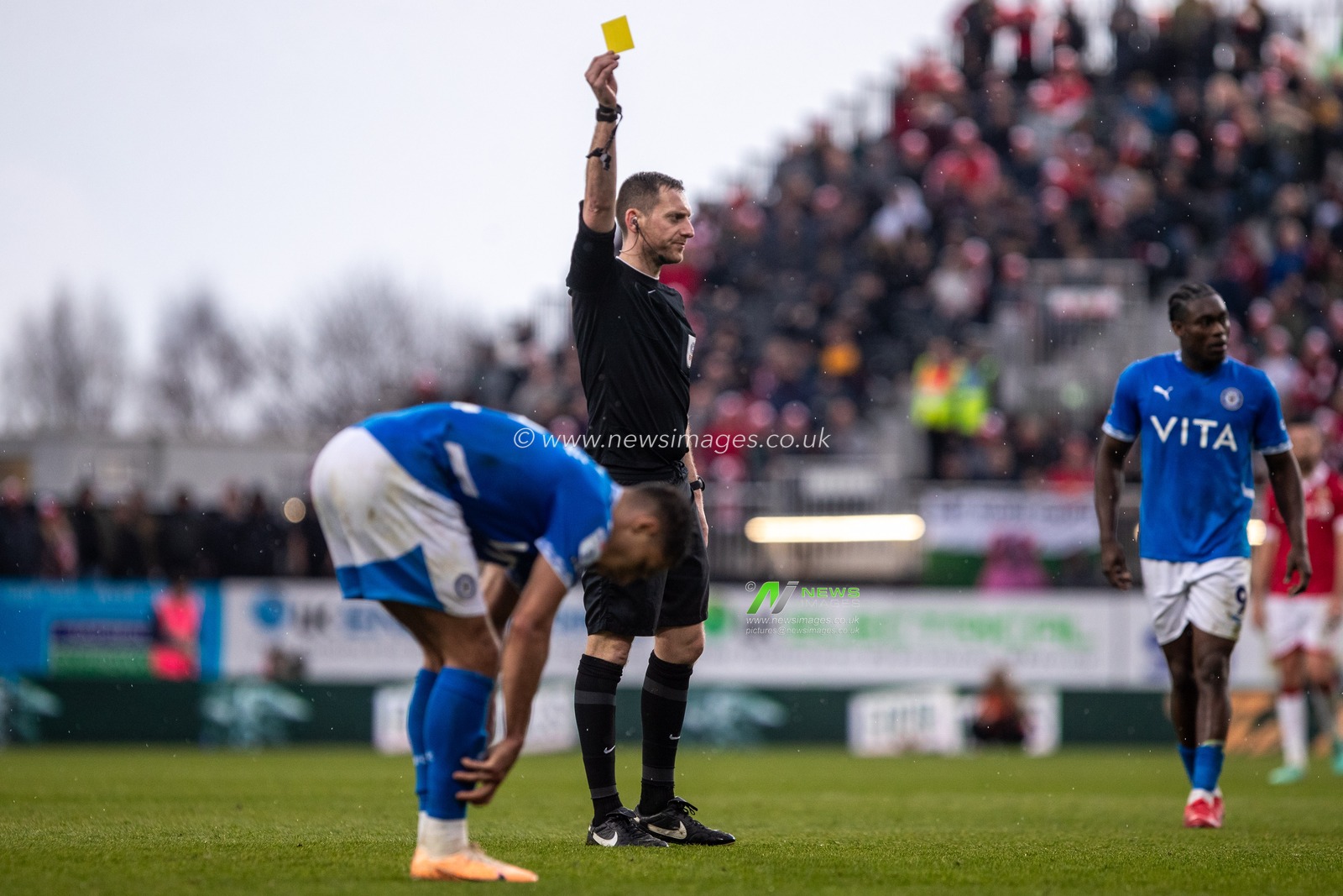 Referee Simon Mather shows a yellow card to Stockport County's Kyle Knoyle during the Sky Bet League 1 match Wrexham vs Stockport County at SToK Cae Ras, Wrexham, United Kingdom, 22nd March 2025

(Photo by Nik Mesney/News Images)