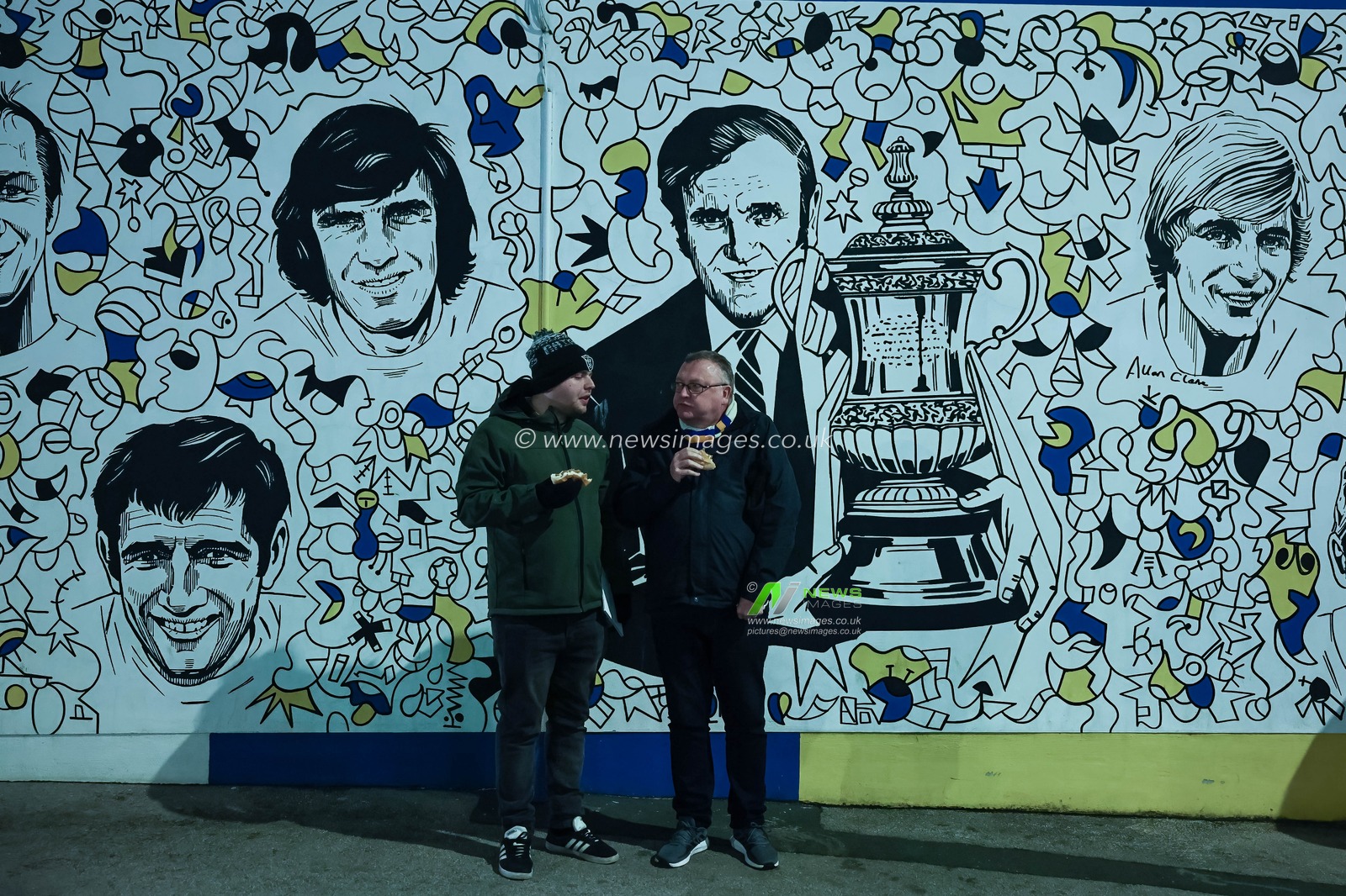 Fans grab a bite to eat on the Leeds United history wall during the Sky Bet Championship match Leeds United vs Middlesbrough at Elland Road, Leeds, United Kingdom, 10th December 2024

(Photo by Mark Cosgrove/News Images)