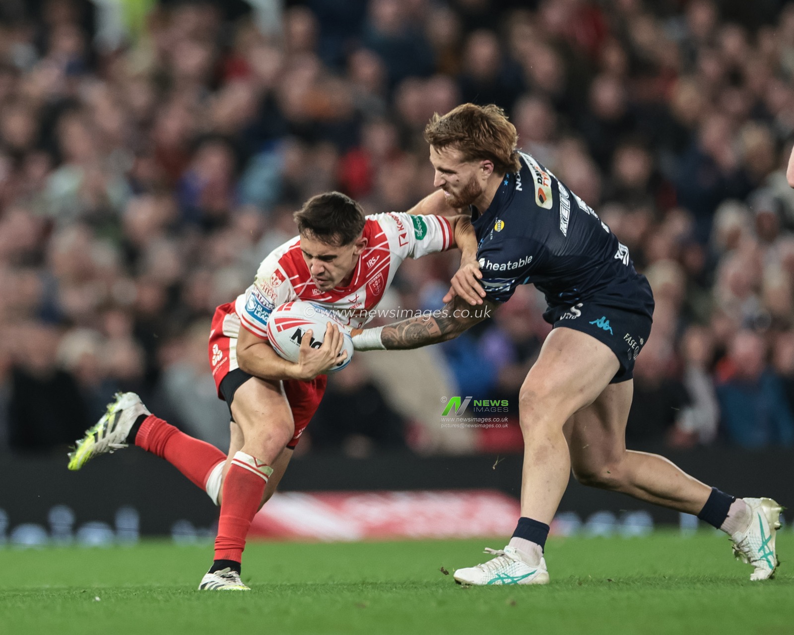 Arthur Mourgue of Hull KR is tackled by Adam Keighran of Wigan Warriors during the 2025 Betfred Super League Grand Final Hull KR v Wigan Warriors at Old Trafford, Manchester, United Kingdom, 11th October 2025

(Photo by Mark Cosgrove/News Images)