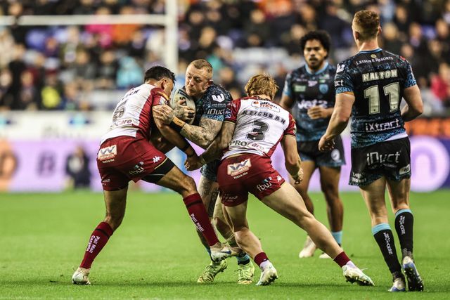 Josh Charley of Leigh Leopards is tackled by Adam Keighran of Wigan Warriors and Bevan French of Wigan Warriors during the Betfred Super League Semi Final 1 match Wigan Warriors vs Leigh Leopards at The Brick Community Stadium, Wigan, United Kingdom, 3rd October 2025

(Photo by Alfie Cosgrove/News Images)