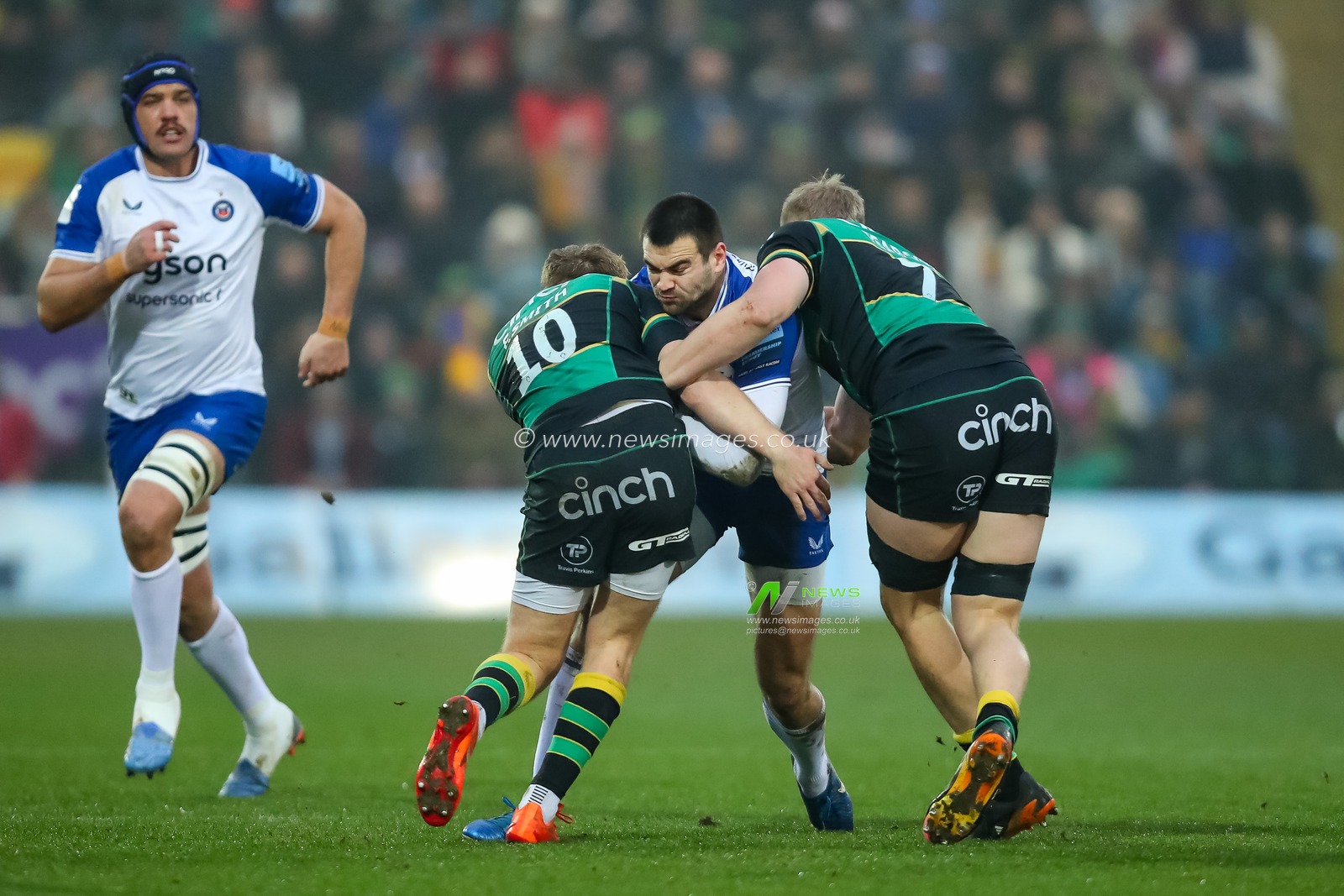 Orlando Bailey of Bath Rugby is tackled by Fin Smith and Tom Pearson of Northampton Saints during the Gallagher Premiership match Northampton Saints vs Bath Rugby at Cinch Stadium at Franklin's Gardens, Northampton, United Kingdom, 5th January 2025

(Photo by Izzy Poles/News Images)