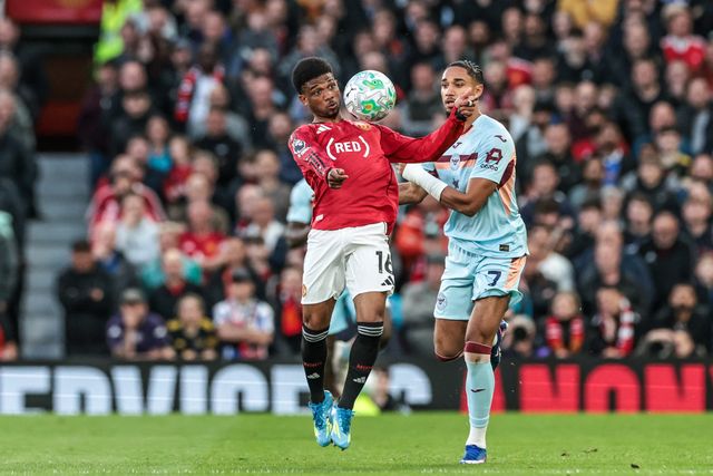 Amad Diallo of Manchester United controls the ball under pressure from Kevin Schade of Brentford during the Premier League match Manchester United vs Brentford at Old Trafford, Manchester, United Kingdom on 27 April 2026

(Photo by Mark Cosgrove/News Images)