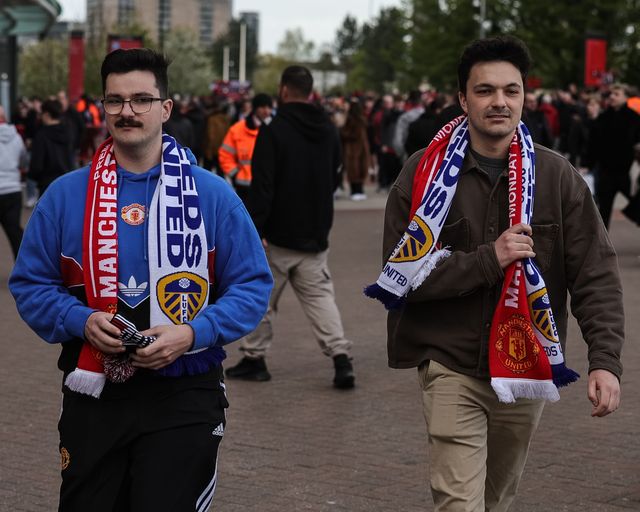 Fans make their way to the game wearing Manchester United v Leeds United scarfs during the Premier League match Manchester United vs Leeds United at Old Trafford, Manchester, United Kingdom on 13 April 2026

(Photo by Mark Cosgrove/News Images)