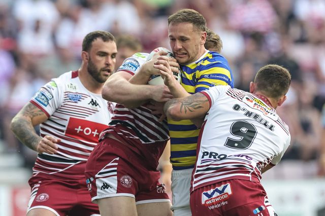 Ben Currie of Warrington Wolves is tackled by Brad O'Neill of Wigan Warriors during the Betfred Super League round 18 match Wigan Warriors vs Warrington Wolves at The Brick Community Stadium, Wigan, United Kingdom on 10 July 2026

(Photo by Mark Cosgrove/News Images)