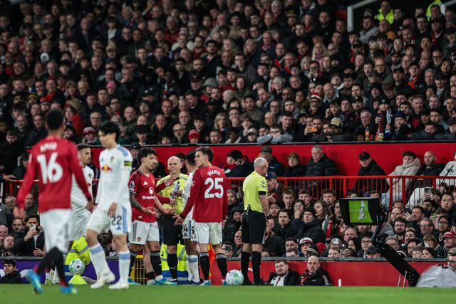 Referee Paul Tierney checks VAR for a possible red card for Lisandro Martinez of Manchester United during the Premier League match Manchester United vs Leeds United at Old Trafford, Manchester, United Kingdom on 13 April 2026

(Photo by Mark Cosgrove/News Images)