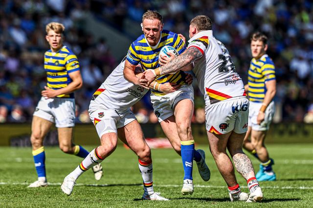 Ben Currie of Warrington Wolves is tackled by Jamie Gill of Bradford Bulls and Will Gardiner of Bradford Bulls during the Betfred Super League round 12 match Warrington Wolves vs Bradford Bulls at The Halliwell Jones Stadium, Warrington, United Kingdom on 24 May 2026

(Photo by Alfie Cosgrove/News Images)