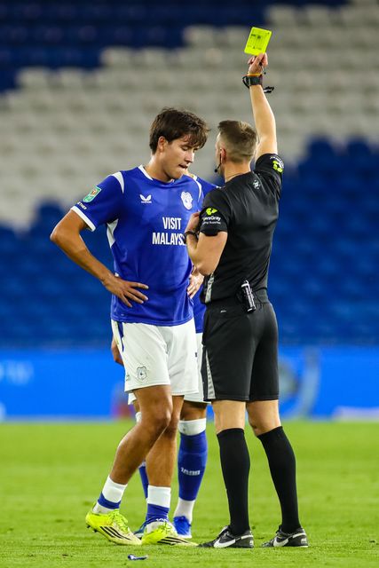 Rubin Colwill of Cardiff City is shown a yellow card by Referee Gavin Ward during the Carabao Cup round 2 match Cardiff City vs Norwich City at Cardiff City Stadium, Cardiff, United Kingdom on 25 August 2026

(Photo by Andrew Lewis/News Images)