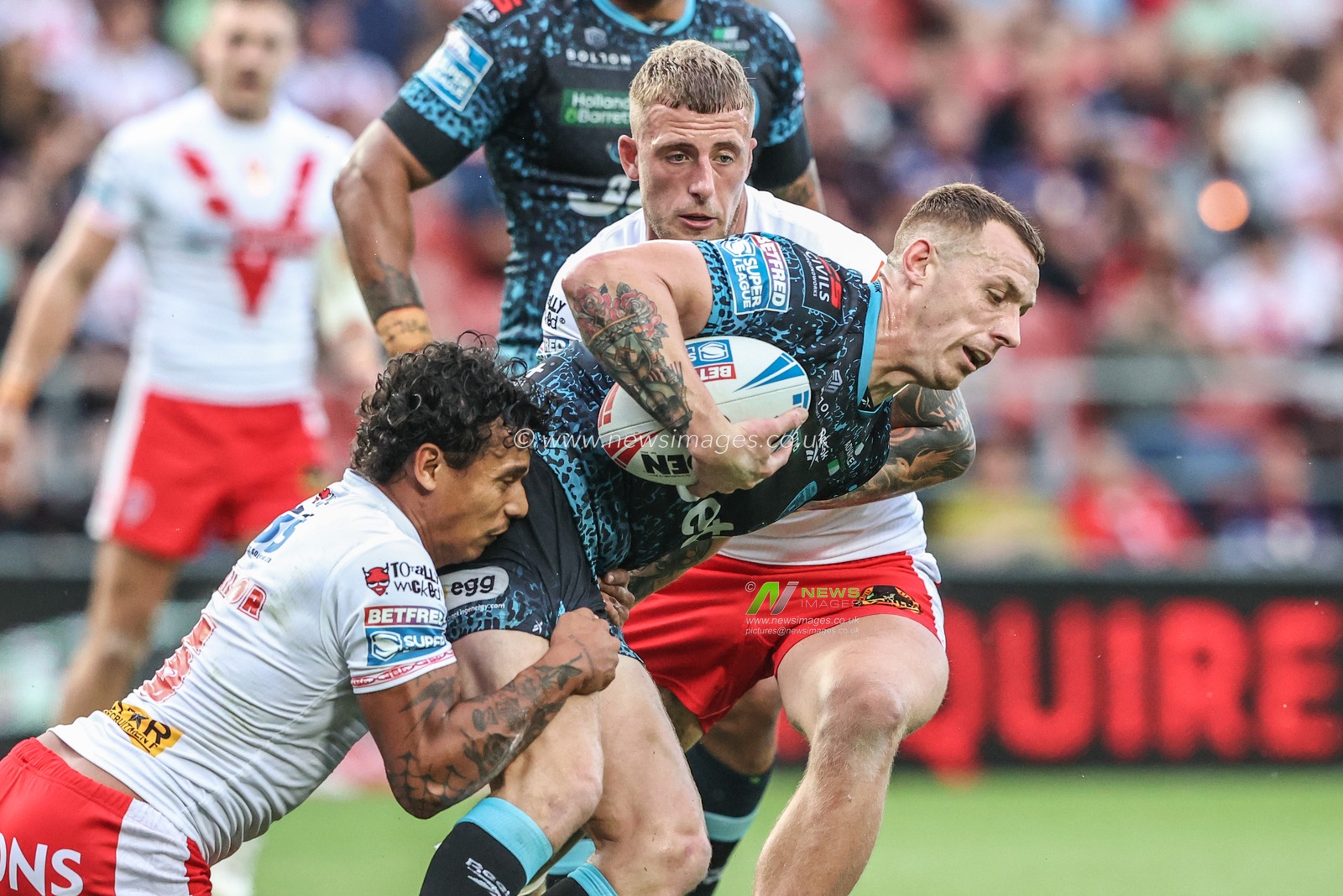 Frankie Halton of Leigh Leopards is tackled by Tristan Sailor of St. Helens during the Betfred Super League round 19 match St Helens vs Leigh Leopards at Totally Wicked Stadium, St Helens, United Kingdom, 17th July 2025

(Photo by Alfie Cosgrove/News Images)