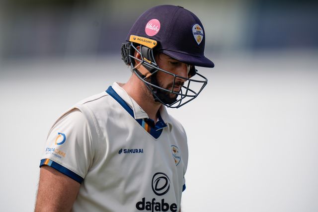 Ben Aitchison walks off after being caught by Cameron Bancroft off the bowling of Craig Miles as Gloucestershire players celebrate a wicket during the County Championship Division Two Derbyshire v Gloucestershire at The Central Co-Op County Ground, Derby, United Kingdom on 26 April 2026

(Photo by Maynard Manyowa/News Images)