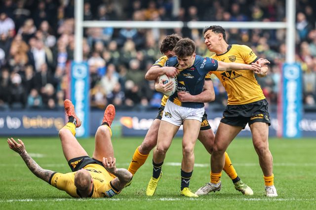 George Brown of Leeds Rhinos is tackled by Daejarn Asi of Castleford Tigers and Joe Stimson of Castleford Tigers during the Betfred Super League round 4 match Leeds Rhinos vs Castleford Tigers at AMT Headingley Stadium, Leeds, United Kingdom on 08 March 2026

(Photo by Alfie Cosgrove/News Images)