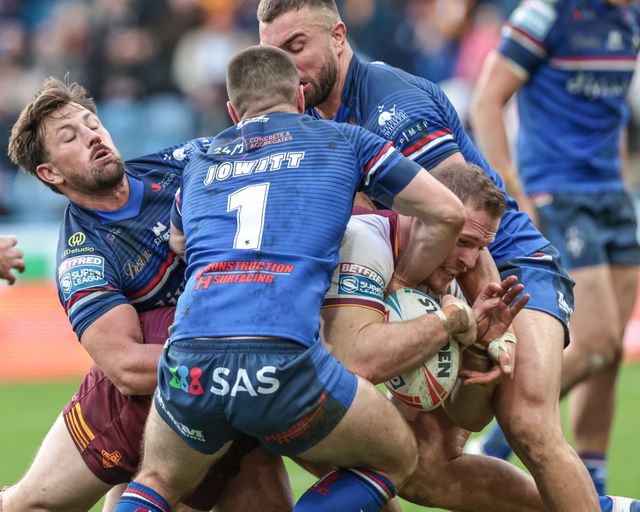 Tom Burgess of Huddersfield Giants is stopped on the try line by Mike McMeeken of Wakefield Trinity and Max Jowitt of Wakefield Trinity during the Betfred Super League Round 2 match Huddersfield Giants vs Wakefield Trinity at Accu Stadium, Huddersfield, United Kingdom on 22 February 2026

(Photo by Mark Cosgrove/News Images)