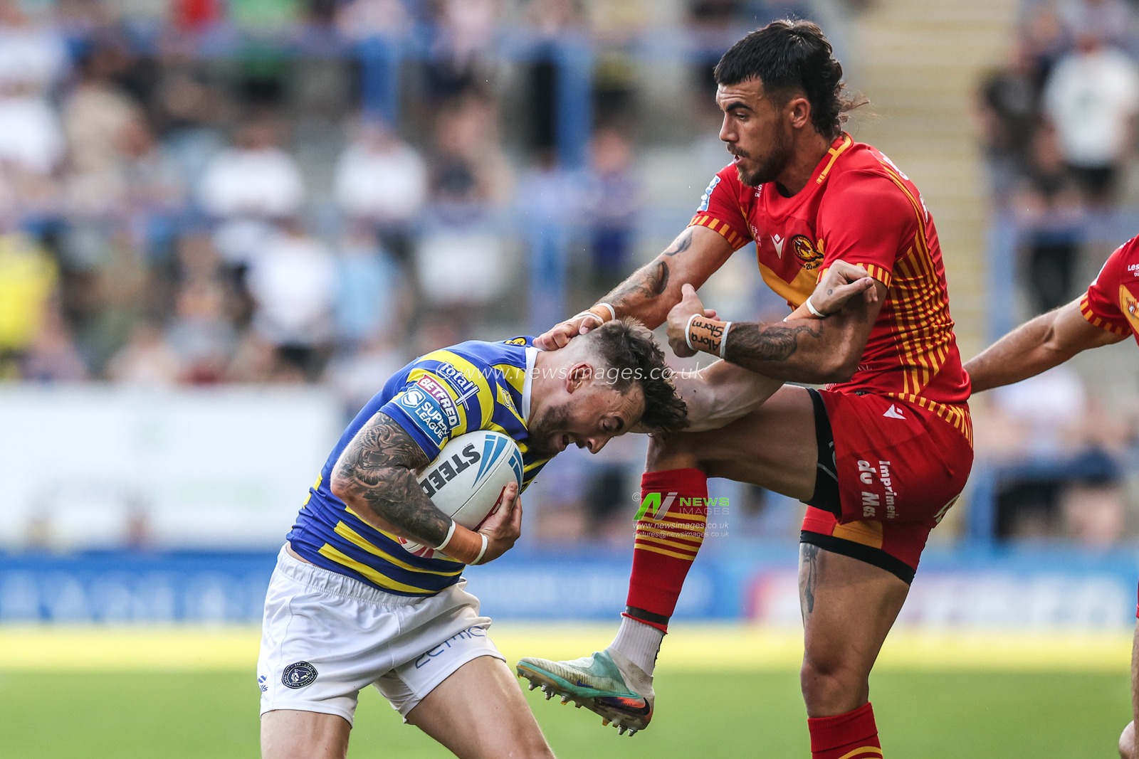 Matty Ashton of Warrington Wolves is tackled by Charlie Staines of Catalans Dragons during the Betfred Super League round 16 match Warrington Wolves vs Catalans Dragons at The Halliwell Jones Stadium, Warrington, United Kingdom on 25 June 2026

(Photo by Alfie Cosgrove/News Images)