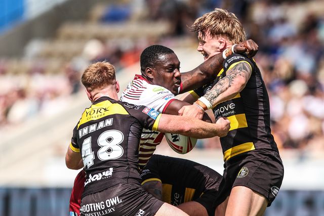 Sam Eseh of Wigan Warriors is tackled by Tom Inman of York Knights and Jack Martin of York Knights during the Betfred Super League round 15 match York Knights vs Wigan Warriors at LNER Community Stadium, York, United Kingdom on 20 June 2026

(Photo by Alfie Cosgrove/News Images)