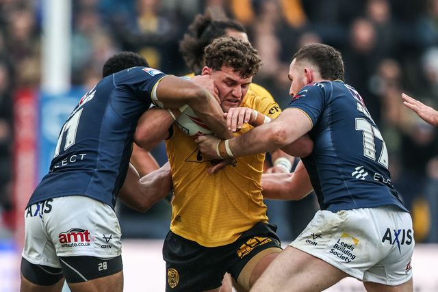 George Lawler of Castleford Tigers is tackled by Tom Holroyd of Leeds Rhinos and Cameron Smith of Leeds Rhinos during the Betfred Super League round 4 match Leeds Rhinos vs Castleford Tigers at AMT Headingley Stadium, Leeds, United Kingdom on 08 March 2026

(Photo by Alfie Cosgrove/News Images)