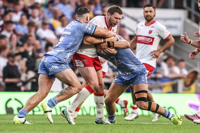 James Batchelor of Hull KR is tackled by Chris Hankinson of Leeds Rhinos and Jake Connor of Leeds Rhinos during the Betfred Super League round 16 match Leeds Rhinos vs Hull KR at AMT Headingley Stadium, Leeds, United Kingdom on 26 June 2026

(Photo by Alfie Cosgrove/News Images)