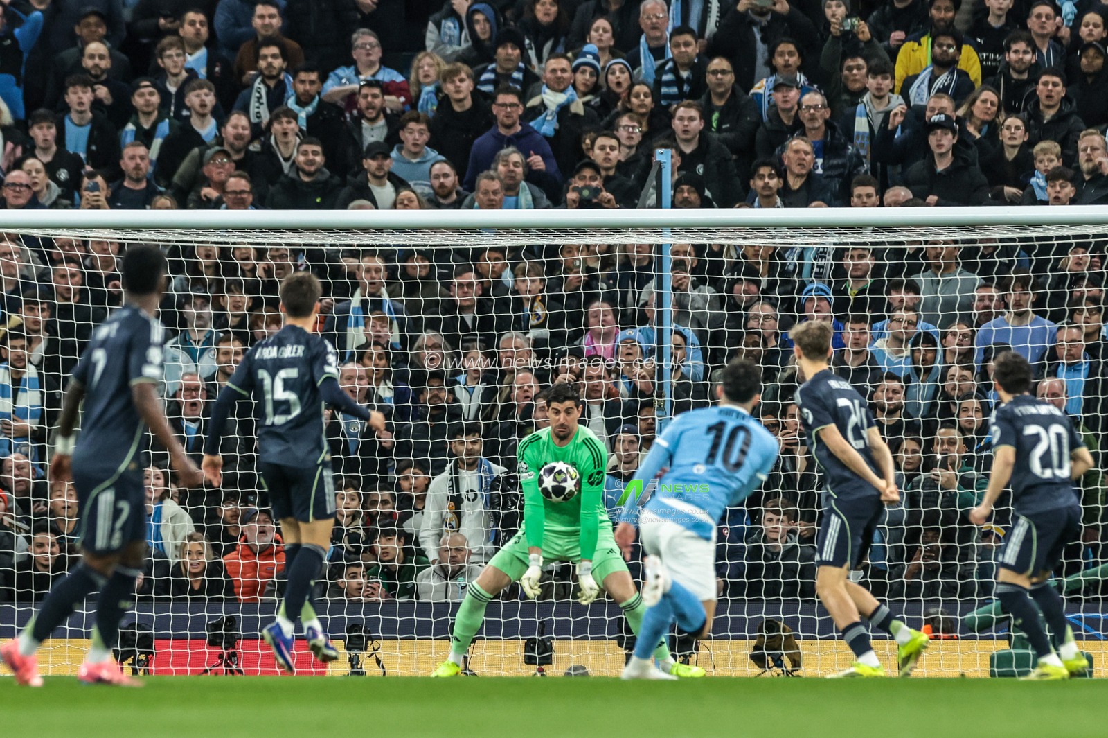 Real Madrid goalkeeper Thibaut Courtois saves a shot on goal from Rayan Cherki of Manchester City during the UEFA Champions League last 16 second leg match Manchester City vs Real Madrid at The City of Manchester Stadium, Manchester, United Kingdom on 17 March 2026

(Photo by Mark Cosgrove/News Images)