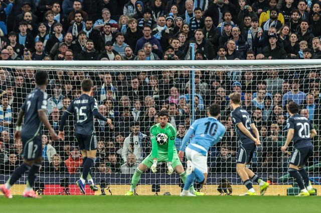 Real Madrid goalkeeper Thibaut Courtois saves a shot on goal from Rayan Cherki of Manchester City during the UEFA Champions League last 16 second leg match Manchester City vs Real Madrid at The City of Manchester Stadium, Manchester, United Kingdom on 17 March 2026

(Photo by Mark Cosgrove/News Images)