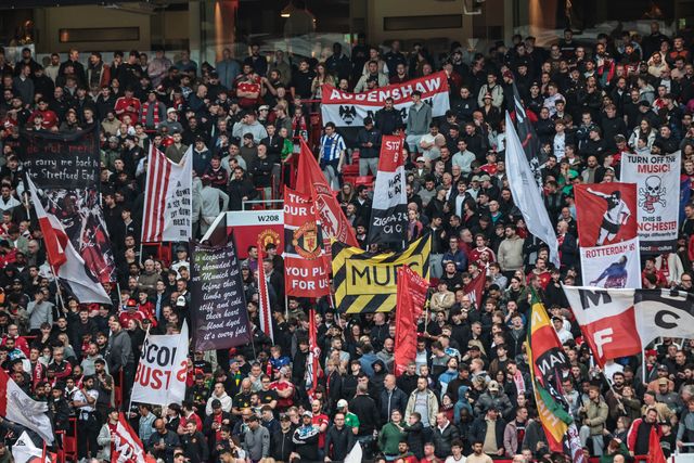Manchester United fans hold up flags before the game during the Premier League match Manchester United vs Brentford at Old Trafford, Manchester, United Kingdom on 27 April 2026

(Photo by Mark Cosgrove/News Images)