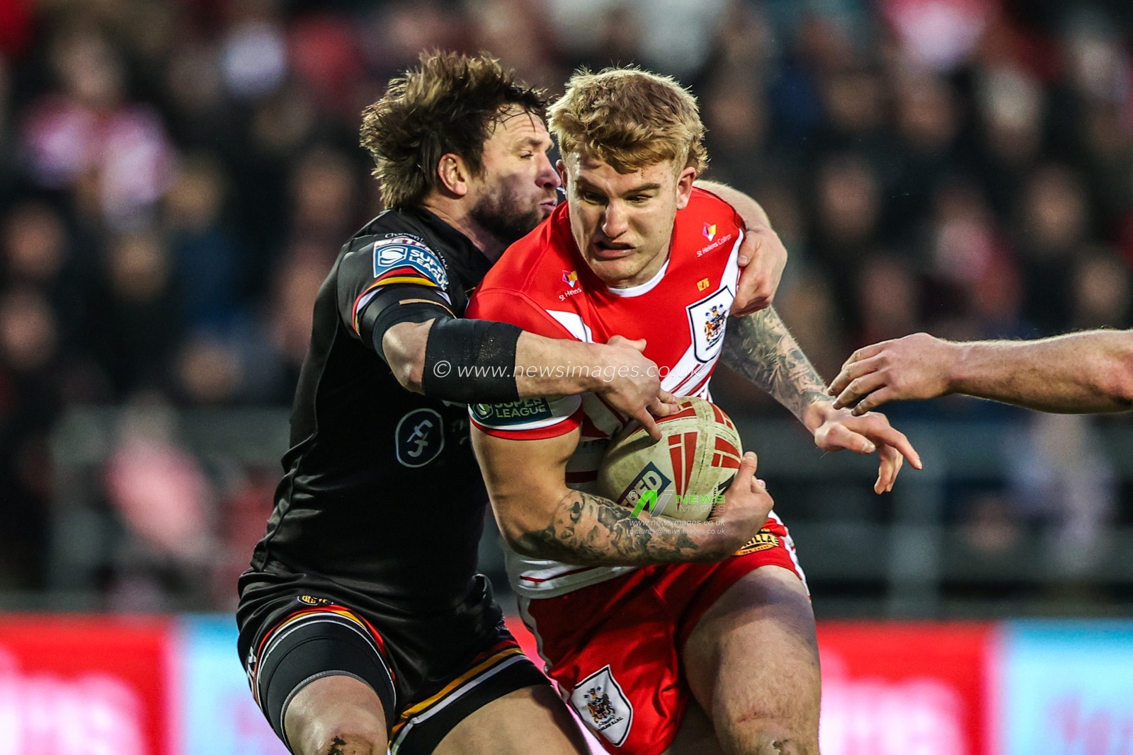 George Delaney of St Helens is tackled by Joe Mellor of Bradford Bulls during the Betfred Super League round 4 match St Helens vs Bradford Bulls at The BrewDog Stadium, St Helens, United Kingdom on 07 March 2026

(Photo by Alfie Cosgrove/News Images)