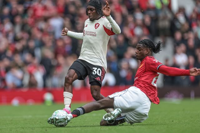 Ayden Heaven of Manchester United slide tackles Jeremie Frimpong of Liverpool during the Premier League match Manchester United vs Liverpool at Old Trafford, Manchester, United Kingdom on 03 May 2026

(Photo by Mark Cosgrove/News Images)