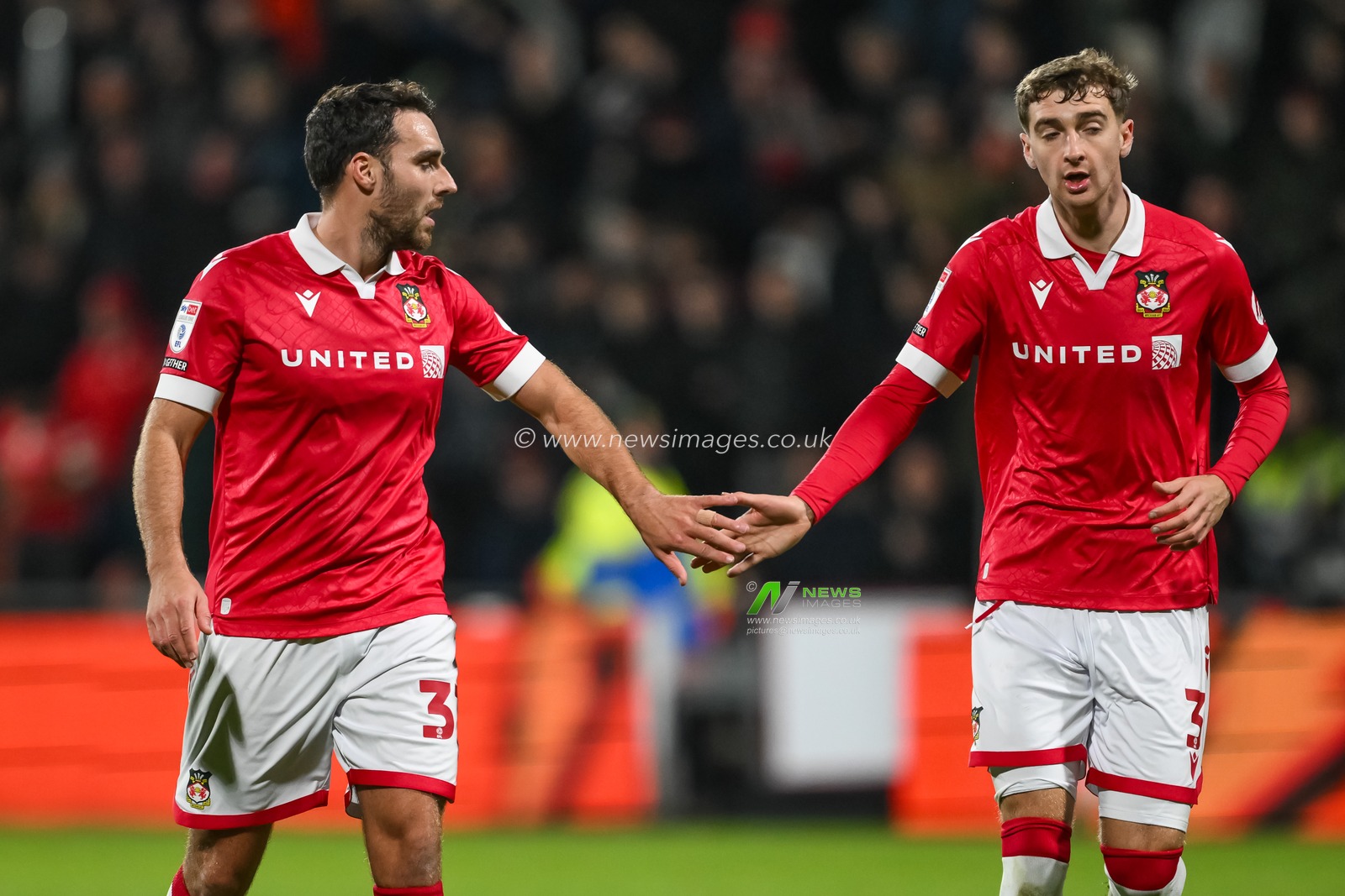 Lewis Brunt of Wrexham hi fives Matthew James of Wrexham have a shot at goal during the Sky Bet League 1 match Wrexham vs Barnsley at SToK Cae Ras, Wrexham, United Kingdom, 3rd December 2024

(Photo by Craig Thomas/News Images)