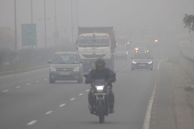 Commuters ride along National Highway NH12 amid dense fog on a cold winter morning in Howrah,West Bengal,Pictures by Debajyoti Chakraborty.(Photo: Debajyoti Chakraborty/News Images)
