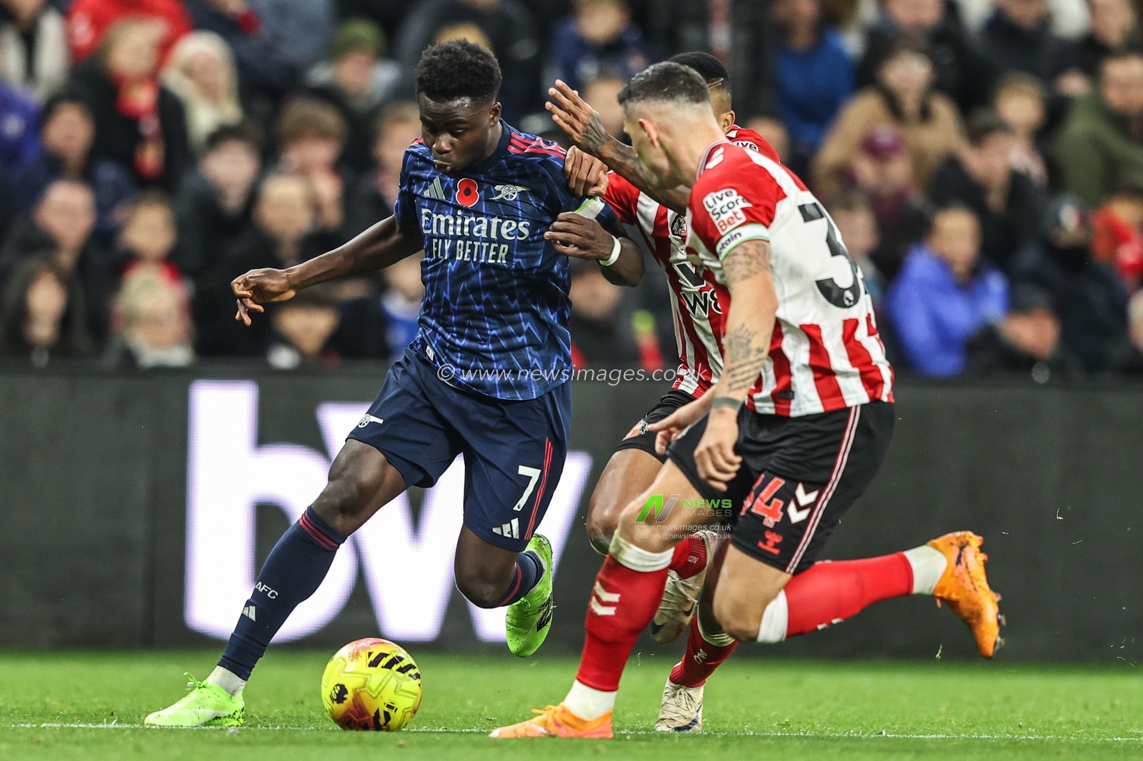Bukayo Saka of Arsenal breaks with the ball under pressure from Granit Xhaka of Sunderland and Reinildo Mandava of Sunderland during the Premier League match Sunderland vs Arsenal at Stadium Of Light, Sunderland, United Kingdom, 8th November 2025

(Photo by Alfie Cosgrove/News Images)

*** GER AUT SUI OUT ***