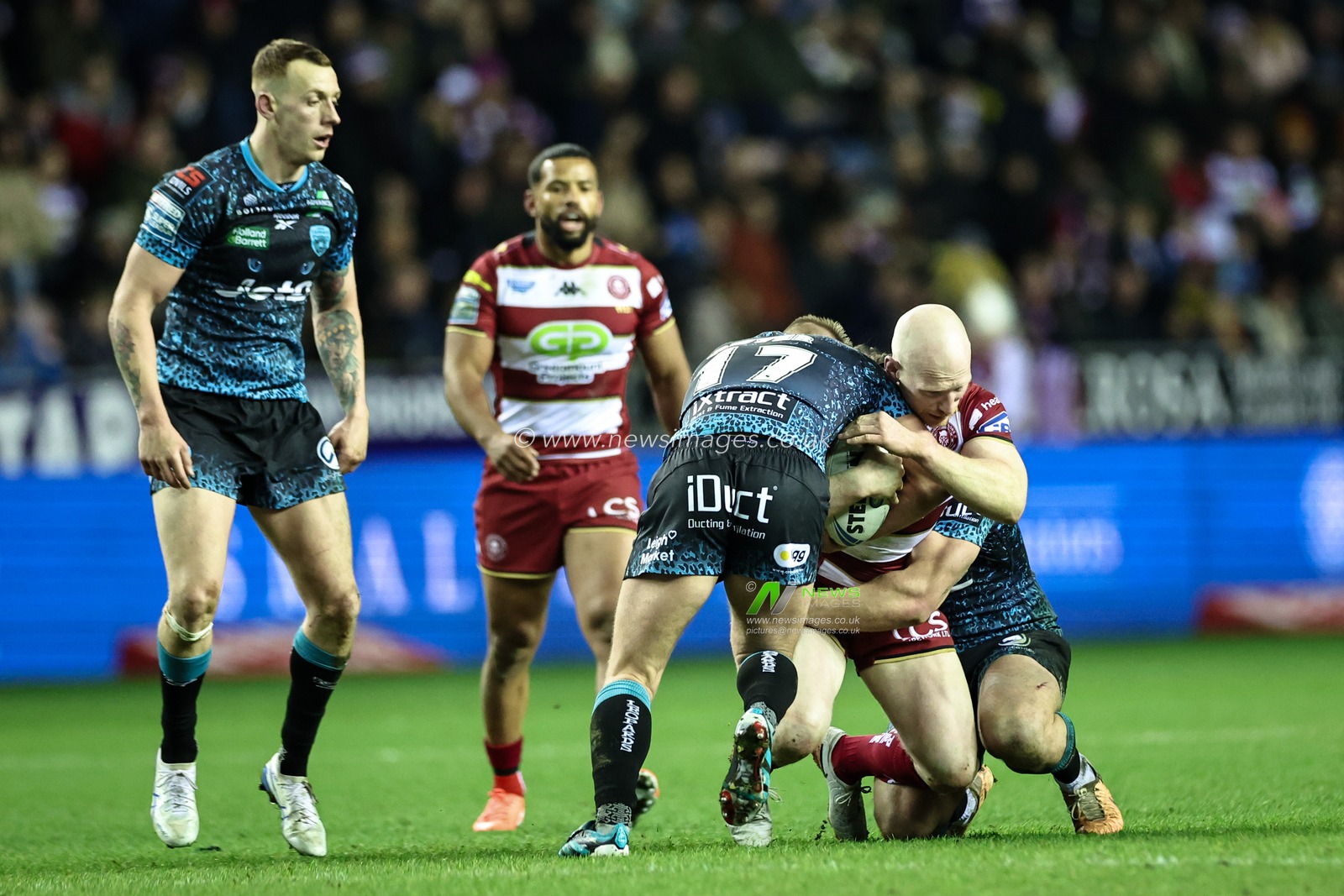 Liam Farrell of Wigan Warriors is tackled by Brad Dwyer of Leigh Leopards during the Betfred Super League Round 1 match Wigan Warriors vs Leigh Leopards at The Brick Community Stadium, Wigan, United Kingdom, 13th February 2025

(Photo by Mark Cosgrove/News Images)