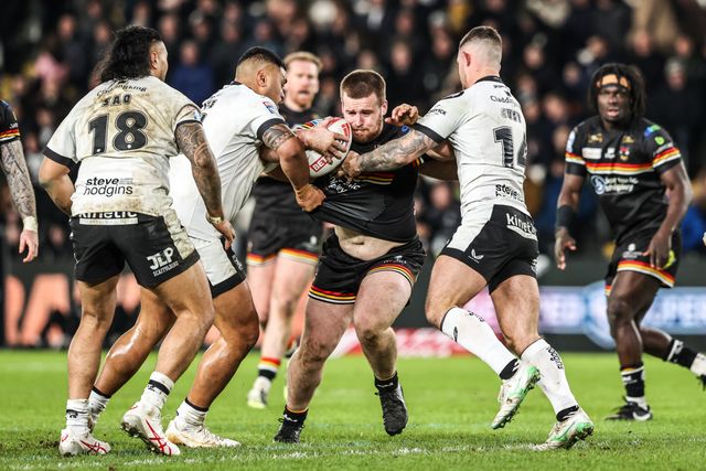 Ebon Scurr of Bradford Bulls is tackled by Cade Cust of Hull FC and Sam Lisone of Hull FC during the Betfred Super League round 1 match Hull FC vs Bradford Bulls at MKM Stadium, Hull, United Kingdom on 14 February 2026

(Photo by Alfie Cosgrove/News Images)