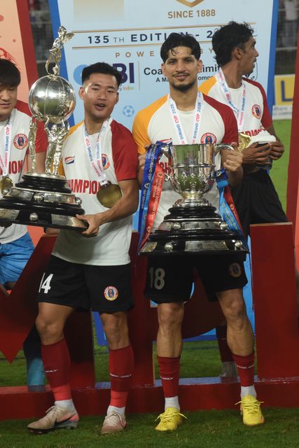 East Bengal FC player Edmund Lalrindika ( left) and Narender celebrates with the championship trophy after winning the 135th Durand Cup final against Mohun Bagan Super Giant at the Vivekananda Yuba Bharati Krirangan in Kolkata, India, August 23, 2026. Photo by Debajyoti Chakraborty.(Photo: Debajyoti Chakraborty/News Images)