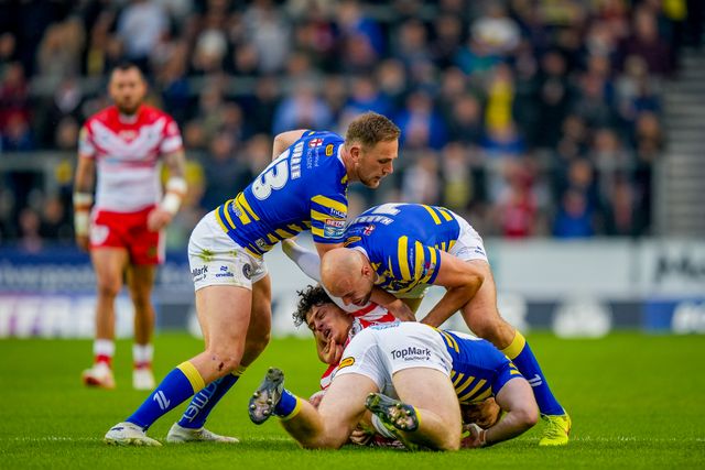 James Harrison of Warrington Wolves and Luke Thomas of Warrington Wolves tackle Jake Burns of St Helens R.F.C. during the Betfred Super League round 14 match St Helens vs Warrington Wolves at The BrewDog Stadium, St Helens, United Kingdom on 11 June 2026

(Photo by Maynard Manyowa/News Images)