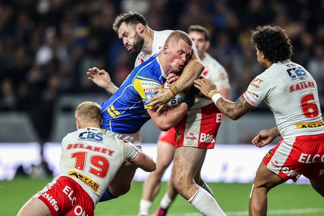 Tom Holroyd of Leeds Rhinos is tackled by George Delaney of St. Helens and Alex Walmsley of St. Helens during the Betfred Super League play-off Eliminator 1 match Leeds Rhinos vs St Helens at Headingley Stadium, Leeds, United Kingdom, 27th September 2025

(Photo by Alfie Cosgrove/News Images)