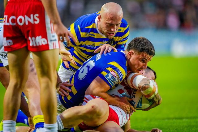 David Klemmer of St Helens R.F.C. is tackled by Josh Smith of Warrington Wolves and James Harrison of Warrington Wolves during the Betfred Super League round 14 match St Helens vs Warrington Wolves at The BrewDog Stadium, St Helens, United Kingdom on 11 June 2026

(Photo by Maynard Manyowa/News Images)