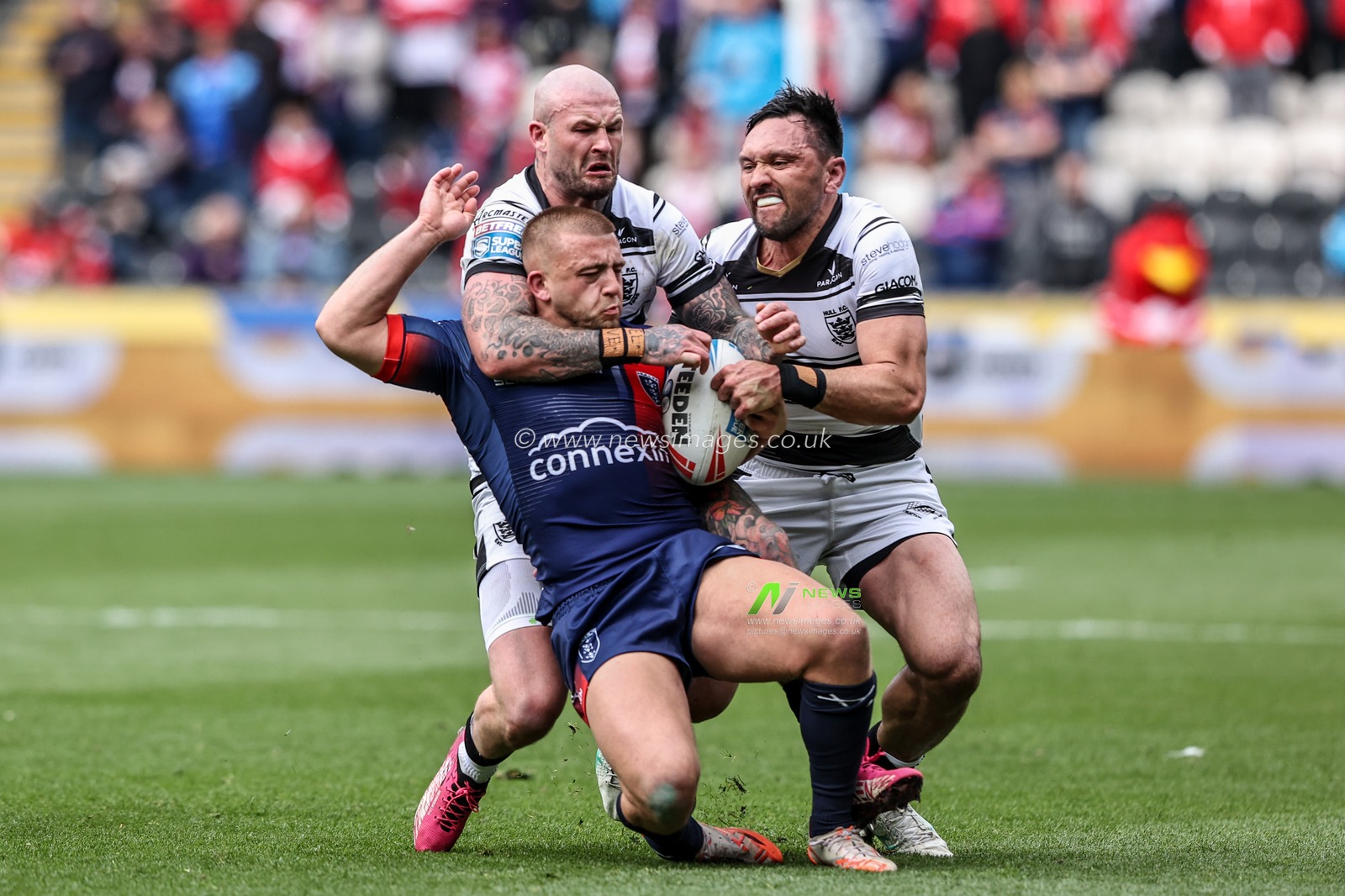 Mikey Lewis of Hull KR is tackled by Jordan Rapana of Hull FC and Zak Hardaker of Hull FC during the Betfred Super League Round 8 match Hull FC vs Hull KR at MKM Stadium, Hull, United Kingdom, 18th April 2025

(Photo by Alfie Cosgrove/News Images)