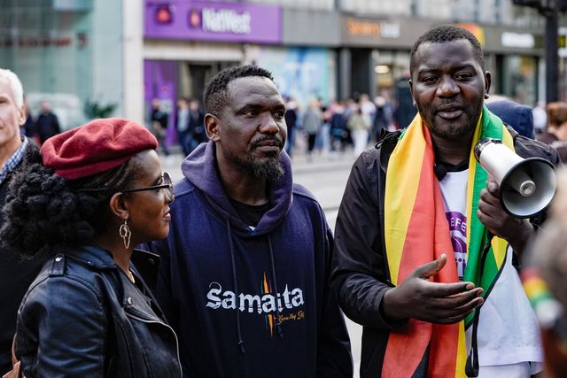 Blessed Mhlanga, Makomborero Haruzvishe and Chenayi Mutambasere UK-based Zimbabweans gather outside the Zimbabwe Embassy in London on 18 April 2026 to protest the Constitution of Zimbabwe Amendment (No. 3) Bill, which critics say would extend President Mnangagwa’s rule until 2030 and strip citizens of the direct vote for president.

(Photo by Maynard Manyowa/News Images)
