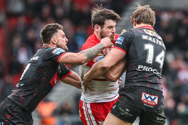 Noah Stephens of St Helens is tackled by Oliver Partington of Wigan Warriors and Sam Walters of Wigan Warriors during the Betfred Super League round 7 match St Helens vs Wigan Warriors at The BrewDog Stadium, St Helens, United Kingdom on 03 April 2026

(Photo by Alfie Cosgrove/News Images)